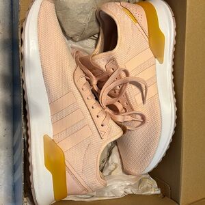 Light pink Adidas, size 9. Never worn. Still in box.